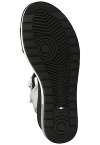 Black rubber shoe sole with a textured pattern, featuring a circular logo, Italian flag detail, and a size marking of 37.