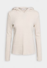 Beige Kapuzenoberteil mit langen Ärmeln in gerippter Struktur, V-Ausschnitt und lässiger Passform. Aus einem weichen, kuscheligen Material gefertigt.