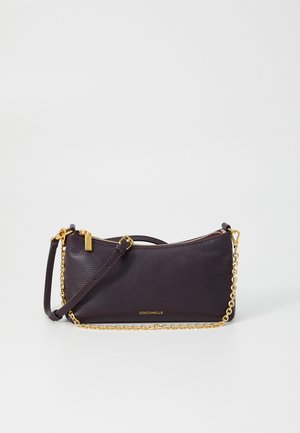 Purple leather clutch with a textured finish, gold chain strap, and zip closure. Brand name embossed on the front. Compact, rectangular shape.