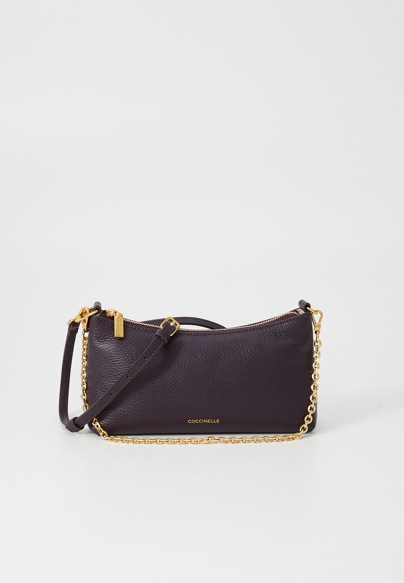 Purple leather clutch with a textured finish, gold chain strap, and zip closure. Brand name embossed on the front. Compact, rectangular shape.