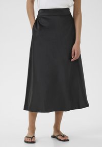 Black satin midi skirt with a fitted waistband, side pockets, and a flowing silhouette. Smooth texture with a slight sheen.