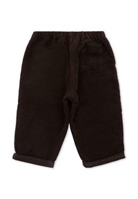 Pantalons en velours côtelé marron avec une coupe loose, une taille élastique, des poignets retroussés et une poche arrière unique. Texture lisse, sans motifs visibles.