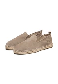 Chaussures slip-on en daim beige avec une semelle extérieure en jute tressé et un bout rond classique, présentant un logo subtil au niveau du talon et une surface texturée uni.