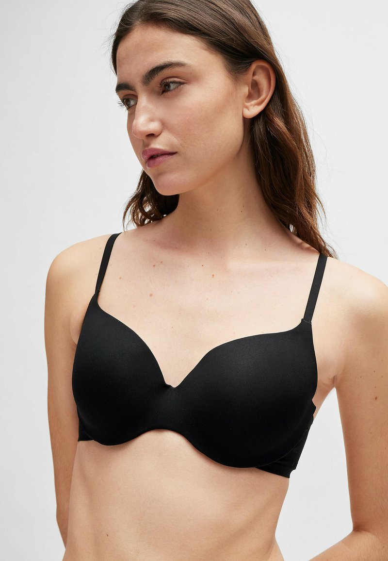 Schwarzer Unterwired-BH mit V-Ausschnitt, glattem Stoff, verstellbaren Trägern und nahtlosen Cups für ein elegantes Erscheinungsbild.