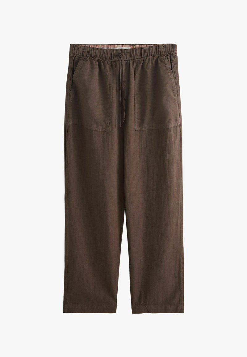 Pantalon marron coupe ample avec taille élastique, cordon de serrage et grandes poches plaquées à l'avant.