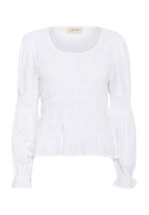 Blusa blanca con textura fruncida, escote en forma de barco y mangas largas abullonadas. Cuenta con tela recogida en la cintura y los puños para un ajuste ceñido.