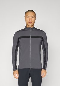 Gray long-sleeve zip-up jacket with black accents and a standing collar. Features a logo on the chest and fitted design for ease of movement.