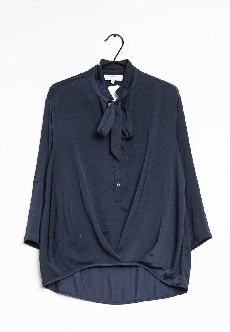 Mörkblus i lätt material med knytkrage, trekvartslånga ärmar och en avslappnad passform med rundad nederkant.