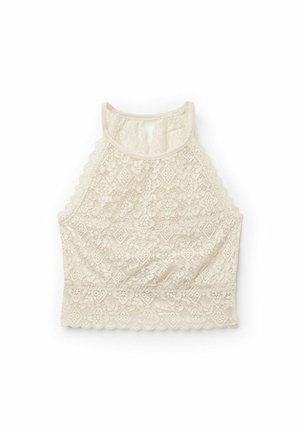 Bralette en dentelle de couleur crème clair, avec un col montant, des bords festonnés, des motifs floraux et un design sans couture.