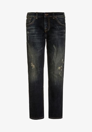 Jean en denim bleu foncé avec des détails décolorés et des patches déchirés sur les cuisses, style classique à cinq poches et fermeture par bouton.