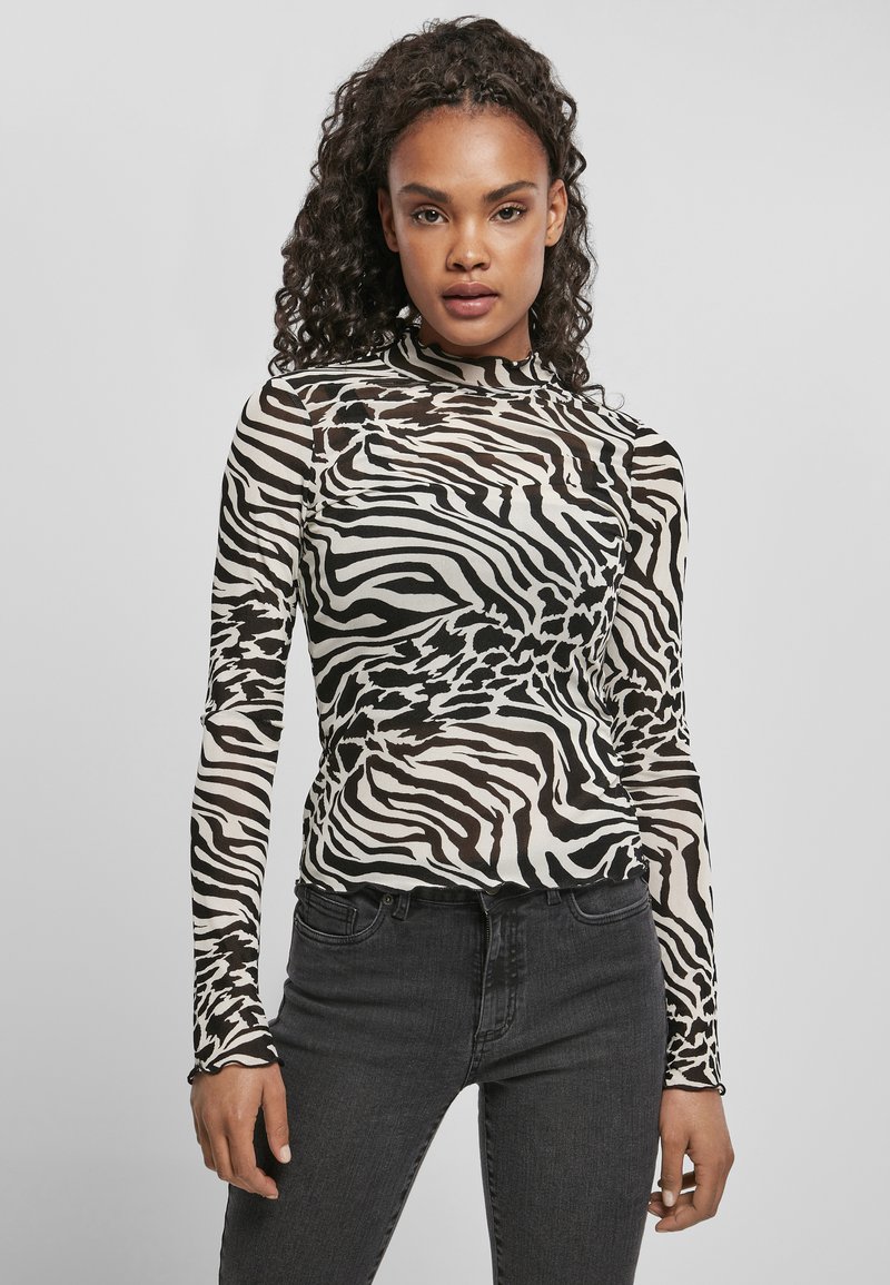 Langsleeve zebra print top van doorzichtig materiaal, met een hoge kraag en een aansluitend ontwerp. Zwart-witte kleuren met subtiele textuur.