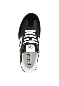 Black and white athletic shoe with a smooth leather upper, white laces, and a cushioned interior. Features logo on the tongue and striped design.