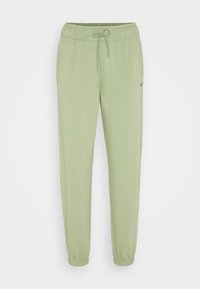 Ljust gröna joggerbyxor med elastisk midja, dragsko och elastiska uddar. Har en subtil svart logotyp på sidan. Mjuk tygkänsla.