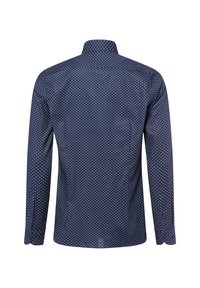Marineblaue Langarmbluse mit kleinen weißen runden Mustern, von hinten betrachtet, mit sichtbarem Kragen und knöpfbaren Manschetten.
