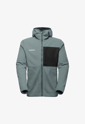 Mammut fleecejack, licht blauw-grijs, volledige rits, hoge hals, zwarte borstzak, zachte textuur, gevormde naden, elastische manchetten.