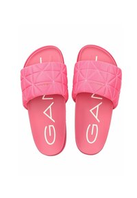 Pink slide sandals with a quilted strap design and flat, textured sole. The brand name “GANT” is prominently displayed in white letters.