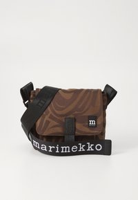 Brown patterned crossbody bag made of fabric, featuring a black adjustable strap with "marimekko" text and a front flap with a magnetic closure.