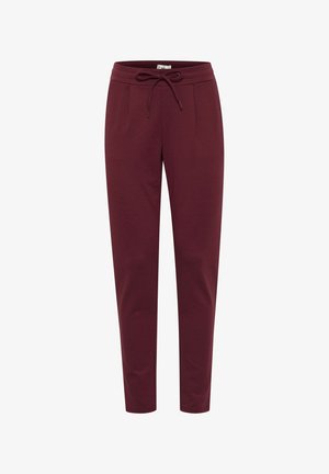 Burgundi värvi püksid, mis on valmistatud pehmest ja elastsetest materjalidest. Neil on tõmblukkude talje, ees pleatid ja kitsenevad sääred. Ühtlane sile tekstuur.