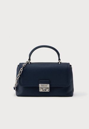 Sac à main en cuir texturé bleu marine avec une poignée supérieure, une bandoulière en chaîne argentée, et une fermeture rectangulaire argentée sur un fond blanc uni.