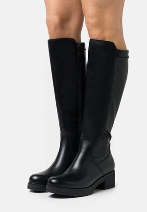 Bottes noires montantes en cuir lisse, avec un bout arrondi et un talon bloc. Fermeture éclair sur le côté et semelle texturée.