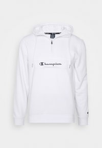 Sweat à capuche blanc Champion avec fermeture éclair à l'avant, cordons sur la capuche, logo Champion sur la poitrine et petit logo sur la manche gauche.