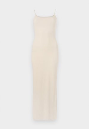 Robe maxi en satin beige avec des bretelles spaghetti fines, corsage ajusté et silhouette droite tombant jusqu'à la cheville. Texture lisse, design minimal.