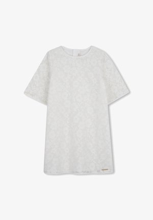 Haut en dentelle florale blanche avec manches courtes, encolure ronde et motif texturé. Comprend une petite étiquette dorée en accent au bas.