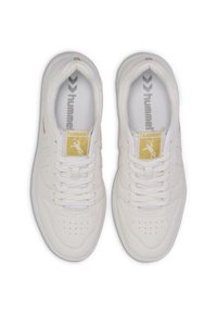 White athletic sneakers with a smooth leather texture, gold accent on tongue, perforated toe, and flat white laces.