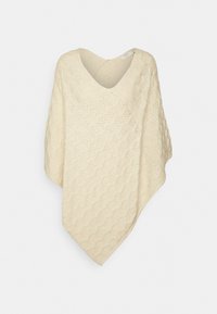 Poncho de cor creme claro com decote em V, feito de um tecido de malha texturizada apresentando um padrão em ondas e detalhes de trabalho aberto, caindo de forma solta.