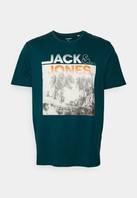 Teal cotton T-shirt featuring a mountain graphic with "JACK & JONES" text in white and orange. Regular fit with a crew neck design.