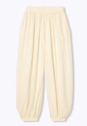 Pantalon ample de couleur crème avec taille élastique et poignets élastiques boutonnés, avec poches latérales et tissu texturé.