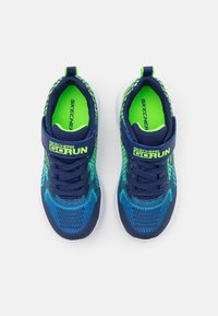 Blue and green mesh athletic shoes with a fabric upper, elastic strap, and white sole. Features a textured pattern and logo detail.