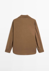 Brown long-sleeve shirt with a collared neckline, featuring a relaxed fit and buttoned cuffs, crafted from soft, textured fabric.