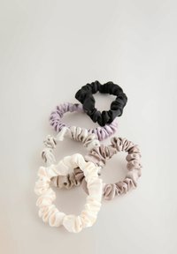 Sæt af fire stofhårscrunchies i sort, lys grå, lavendel og creme. Blød tekstur med samlet stof for fleksibilitet og greb.