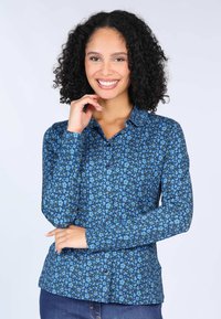 Long-sleeve blue button-up shirt featuring a floral print in light blue and green, with a collar and smooth fabric texture.