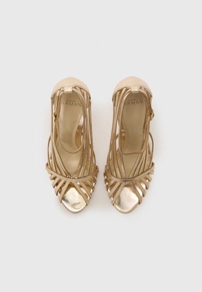 Strappy high-heeled shoes in metallic gold with a smooth toe cap and intertwining straps, featuring a secured ankle strap for support.