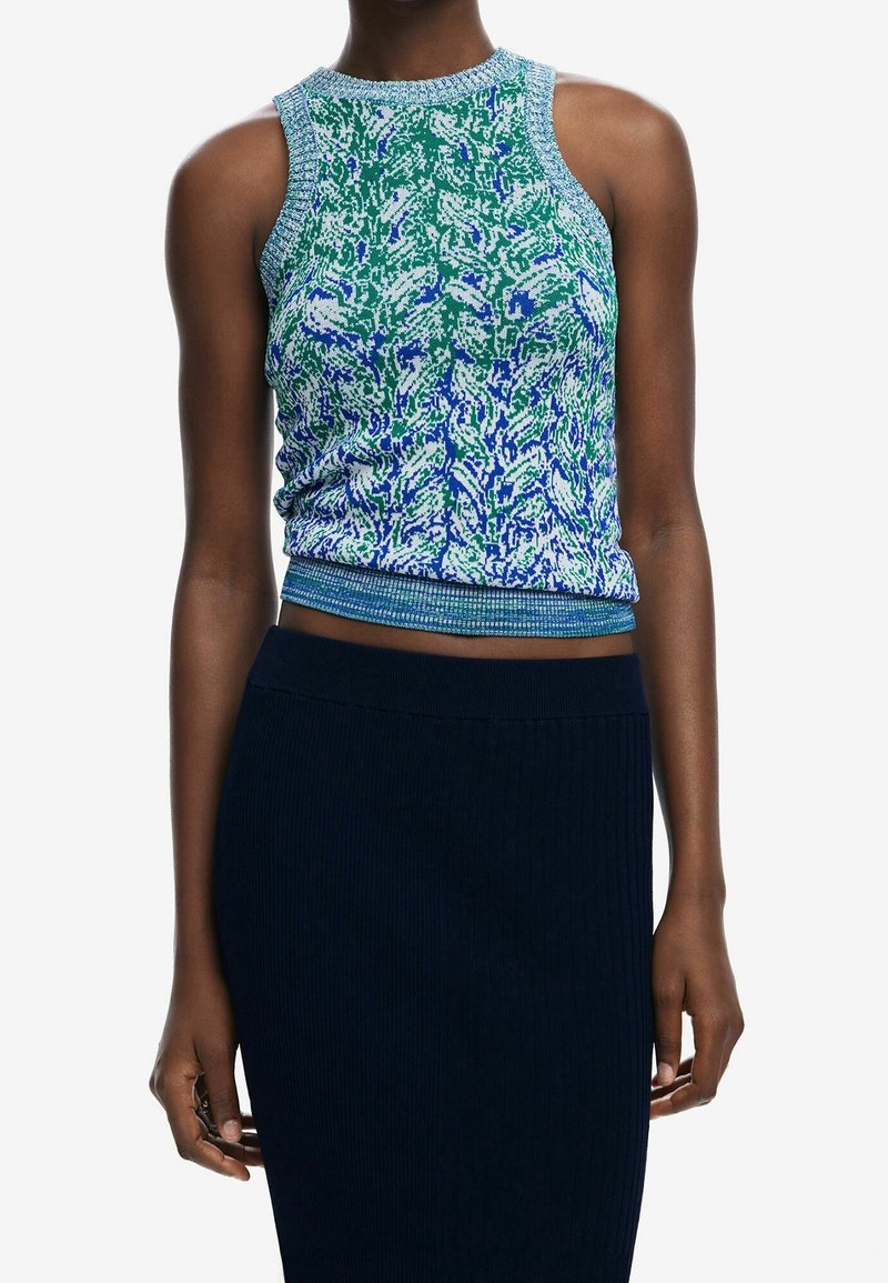 Top senza maniche in maglia con motivo multicolore verde e blu, aderente con orlo a costine. Abbinato a una gonna scura a coste.