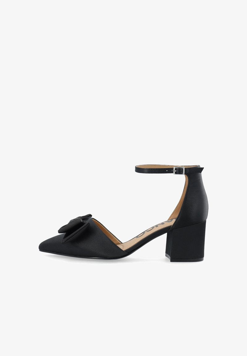 Black satin high-heeled shoe with a pointed toe, ankle strap, and a bow accent on the vamp. Chunky block heel design.