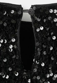 Tessuto nero con paillettes circolari, caratterizzato da un collo a chiave e una chiusura con bottone. Superficie testurizzata e lucida con dettagli in evidenza.
