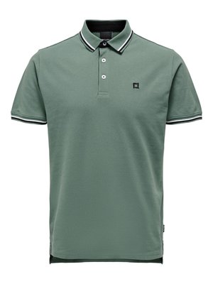 Short-sleeve green polo shirt with black-and-white striped collar and sleeve edges, two buttons, and small black logo on the chest.