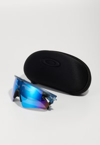 Blue-tinted sports sunglasses with a wrap-around design, featuring a black-accented frame and a black protective hard case.