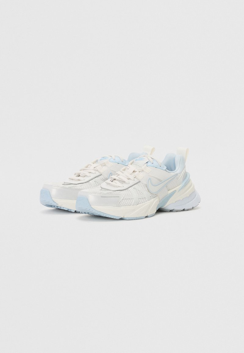 Zapatillas deportivas blancas y azul claro con parte superior de malla y sintética, diseño texturizado, cuello acolchado y suela de goma. Presenta el logo de Nike.