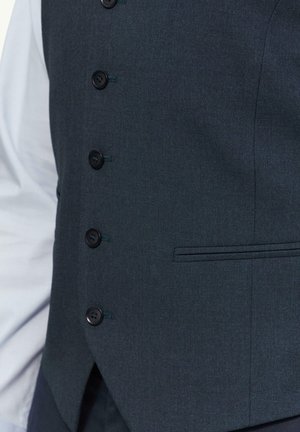 Dunkelblaues Weste aus strukturiertem Stoff, mit sechs schwarzen Knöpfen und einer Seitentasche. Das Design ist figurbetont mit einem scharfen Schnitt.