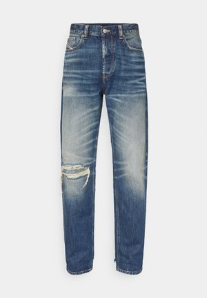Blue denim jeans with a straight fit. Notable distressed elements include a rip on the left knee and subtle fading on the fabric.