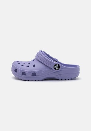 Lilla skumklomper med ventilasjonsåpninger, en bakre stropp og en strukturert såle. Designet er lett og tilpasser seg føttens form.