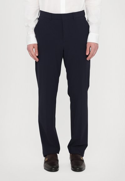 Marineblaue Hose aus glattem Stoff mit schmaler Beinform; verfügt über einen mittelhohen Bund und elegante Vorderfalten.
