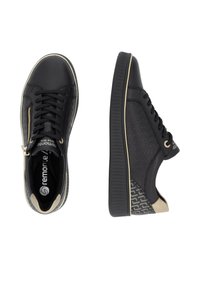 Baskets en cuir noir avec un panneau latéral texturé, des accents dorés et un talon beige contrasté. Design à lacets avec un détail de zipper.