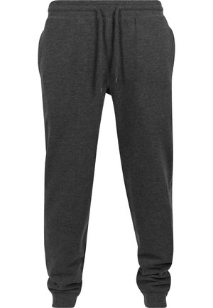Pantaloni de trening gri închis dintr-un material moale, cu talie elastică prevăzută cu șnur, gleznă strânsă și o croială relaxată.
