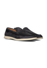 Zwarte suede instapschoenen met een gladde afwerking, beige rubberen zool en subtiele stikdetails langs de randen.