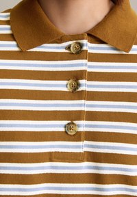Brown en witte gestreepte polo met een kraag en drie bruine knopen. Het materiaal lijkt gestructureerd en heeft een klassieke pasvorm.